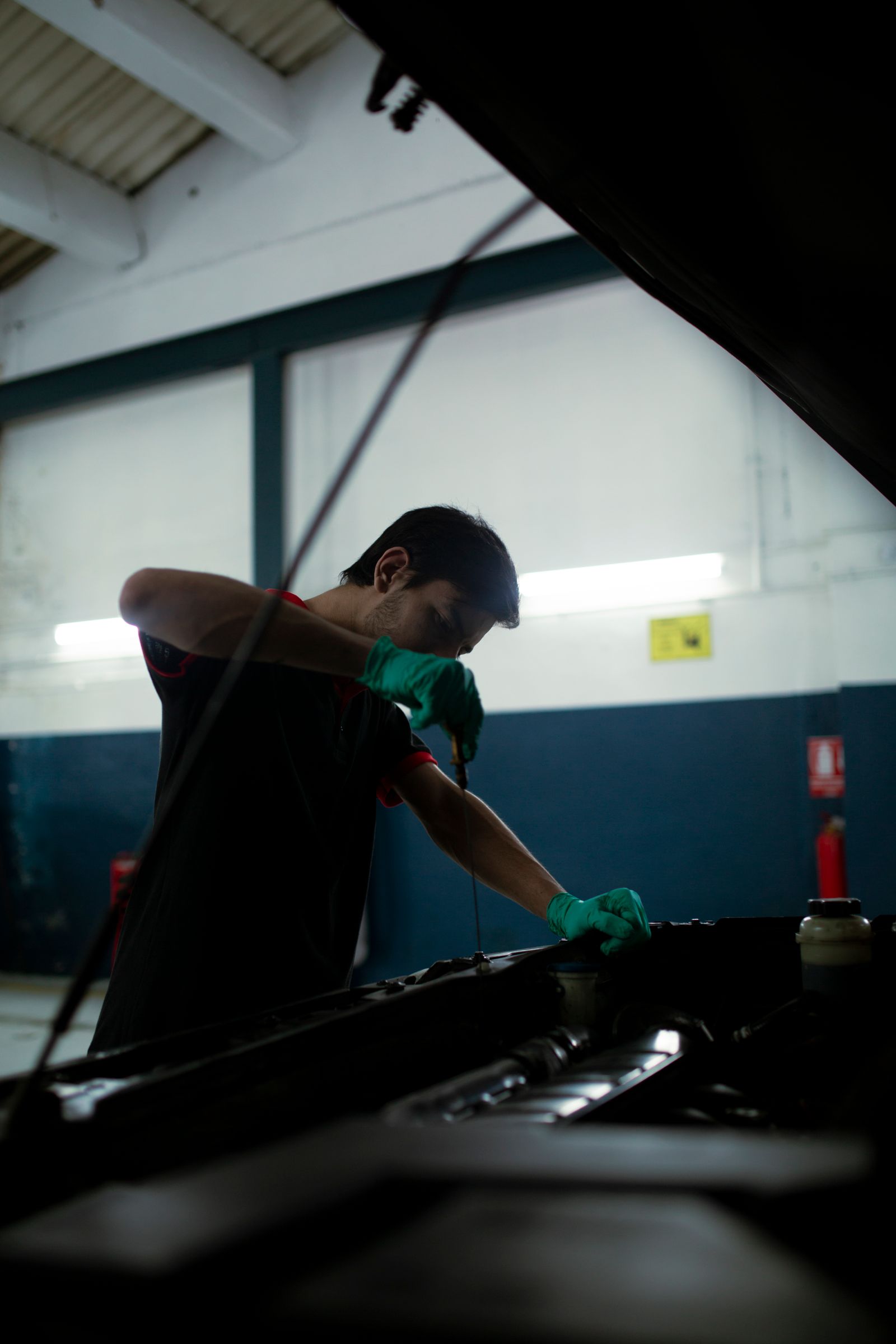 Mechanic working under the hood of a vehicle